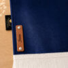 Zoom sur la personnalisation en cuir véritable de couleur marron portant votre prénom du tapis de prière Sajadah pour enfant bleu Nuit.