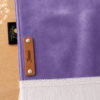 Zoom sur la personnalisation en cuir véritable de couleur marron portant votre prénom du tapis de prière Sajadah pour enfant violet.